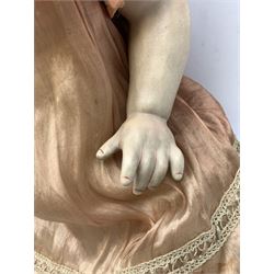 German bisque head doll with applied hair, sleeping eyes and open mouth with teeth and fixed tongue, on composition body with jointed limbs, marked 'P.M. 914 Germany 14' H65cm