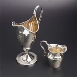 George III silver helmet shape cream jug with loop handle, engraved with a monogram on cir...