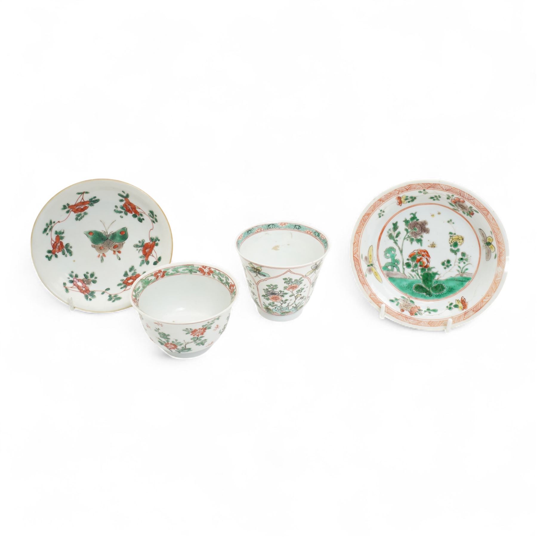 Three Chinese famille verte examples, approximately Yongzheng period, to include two teabowls and two saucers, each decorated with flowers and butterflies, two with sacred fungus mark within double rings, the teabowl with lotus mark, the other indistinct - possibly a Wan mark within lozenge (4)