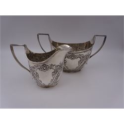 Late Victorian silver milk jug and twin handled open sucrier, each of oval form with angular handles and embossed floral, foliate and C scroll decoration, hallmarked James Deakin & Sons, Sheffield 1899, sucrier with handles H10.8cm