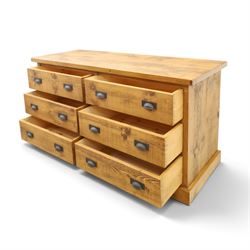 Indigo Furniture - large rustic oak chest, rectangular top fitted with six drawers with metal pull handles, on skirted base