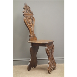  Italian Renaissance style carved walnut hall chair, vase shaped back carved with mask head, shells and scrolls, solid seat and supports, H113cm  