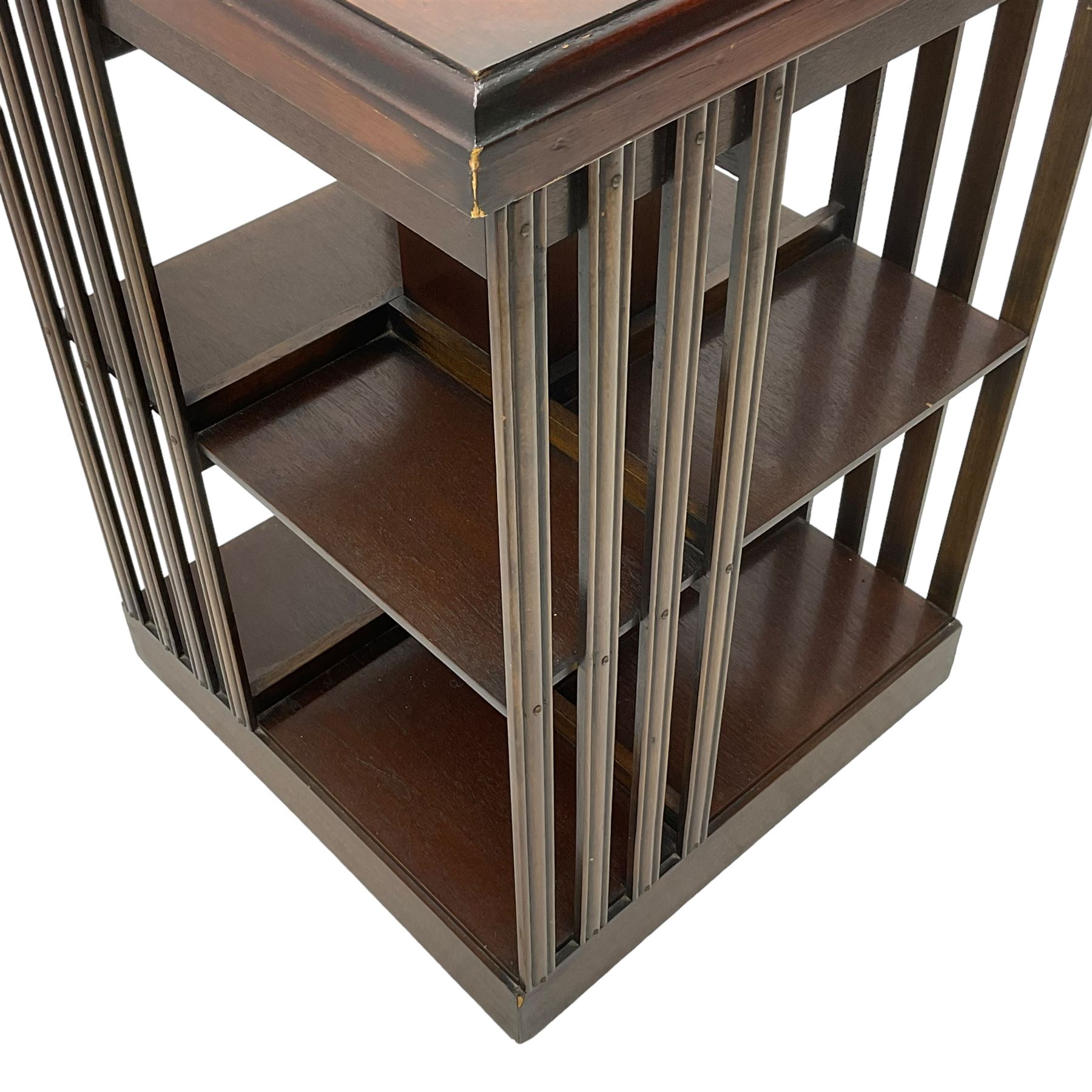 Edwardian revival inlaid mahogany revolving bookcase, square form with moulded top inlaid with central fan motif, two-tiers with moulded upright rails, on castors 
