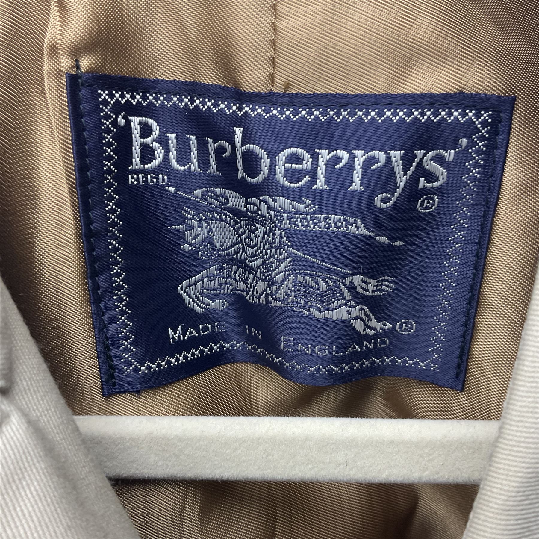 Ladies Burberry double breasted trench coat, with belt and detachable woollen gilet, in traditional cream colour with Burberry check lining, together with a gentlemans Burberry single breasted trench coat, both L112cm