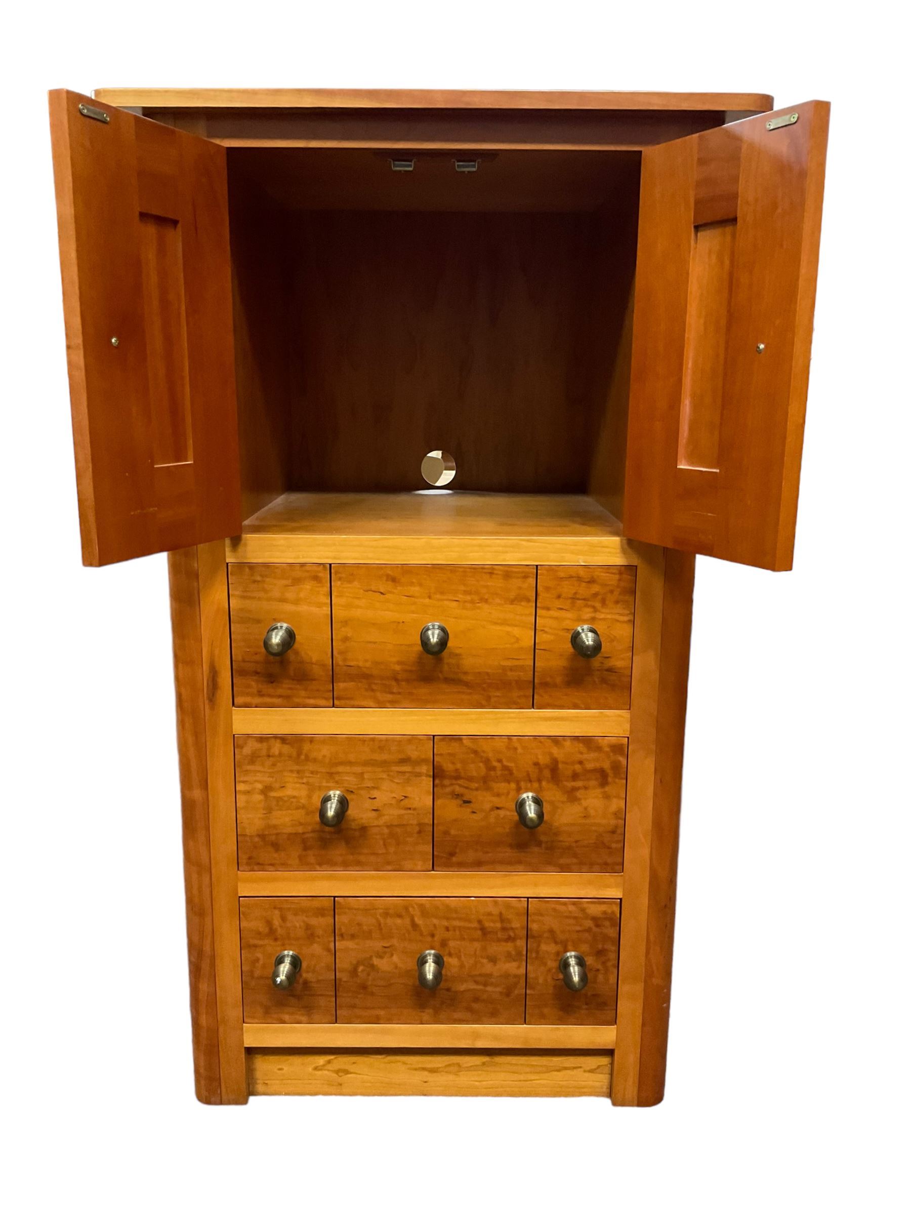 Large contemporary cherry wood break-front wall unit, the banded cornice over double cupboard with bifold doors and two drawers, flanked by four single cupboards, the base fitted with four drawers over four cupboards (W263cm, H216cm, D68cm); and a cherry wood cabinet, fitted with double cupboard over two short and two long drawers, with faux drawer facias (W81cm, H138cm, D66cm)