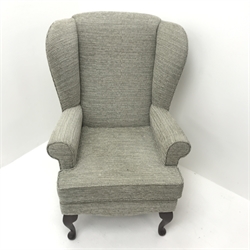 High seat wing back armchair, upholstered in a beige ground patterned fabric, cabriole legs, W73cm