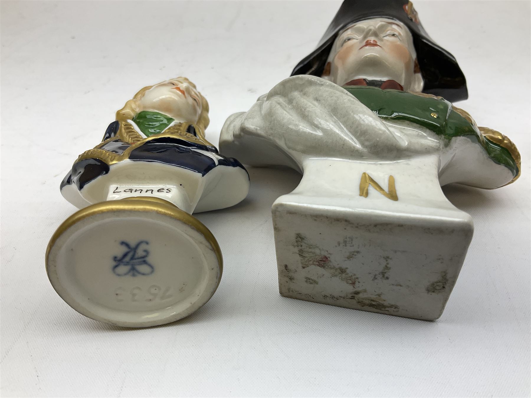 Group of Napoleonic busts comprising ‎Rudolf Kämmer Volkstedt examples of General Jean Lannes, 1st Duc de Montebello and Scottish Highland Infantry soldier and Rifleman 1803, all with blue crowned K marks beneath, and a bust of Napoleon raised upon square plinth, tallest H12cm