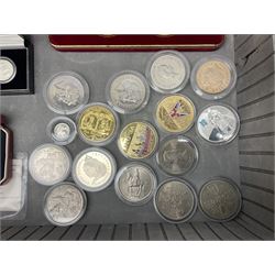 The Royal Mint United Kingdom 1977 silver proof two coin set, Queen Elizabeth II 2002 silver proof three coin set, comprising Bailiwick of Jersey, Bailiwick of Guernsey, and Alderney five pound coins, 'First Coinage of the British Virgin Islands' proof set, 1997 1/10 ounce fine silver Britannia, two King George V 1935 'Rocking Horse' crowns, various Isle of Man commemorative crowns, etc., house in a hard shell carry case