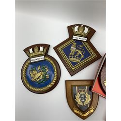 Various Navy wooden heraldic shields each with hand painted raised shield, including HMS Indefatigable, HMS Nelson,  HMS Victory etc, ten in total.  