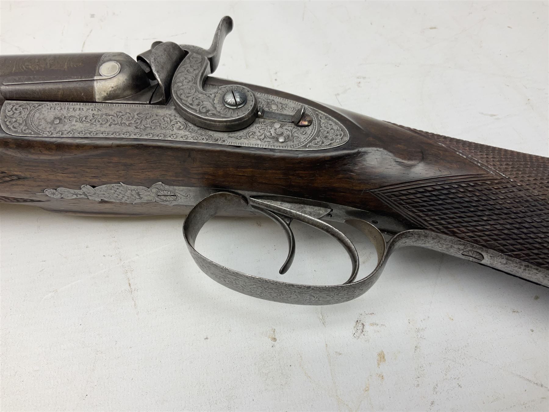 19th century John Jefferson of Scarborough 6-bore (modern 4-bore) double barrel side-by-side percussion gun, with 81cm stub twist damascus barrels (no provision for ramrod), well figured walnut stock with fine chequered grip and fore-end with horn tip and steel butt plate with long tang, well engraved lock and hammers with half-cock safeties on both sides, barrel sling swivel but rear sling swivel removed and replaced with silver escutcheon, London proofmarks, NVN, L128cm