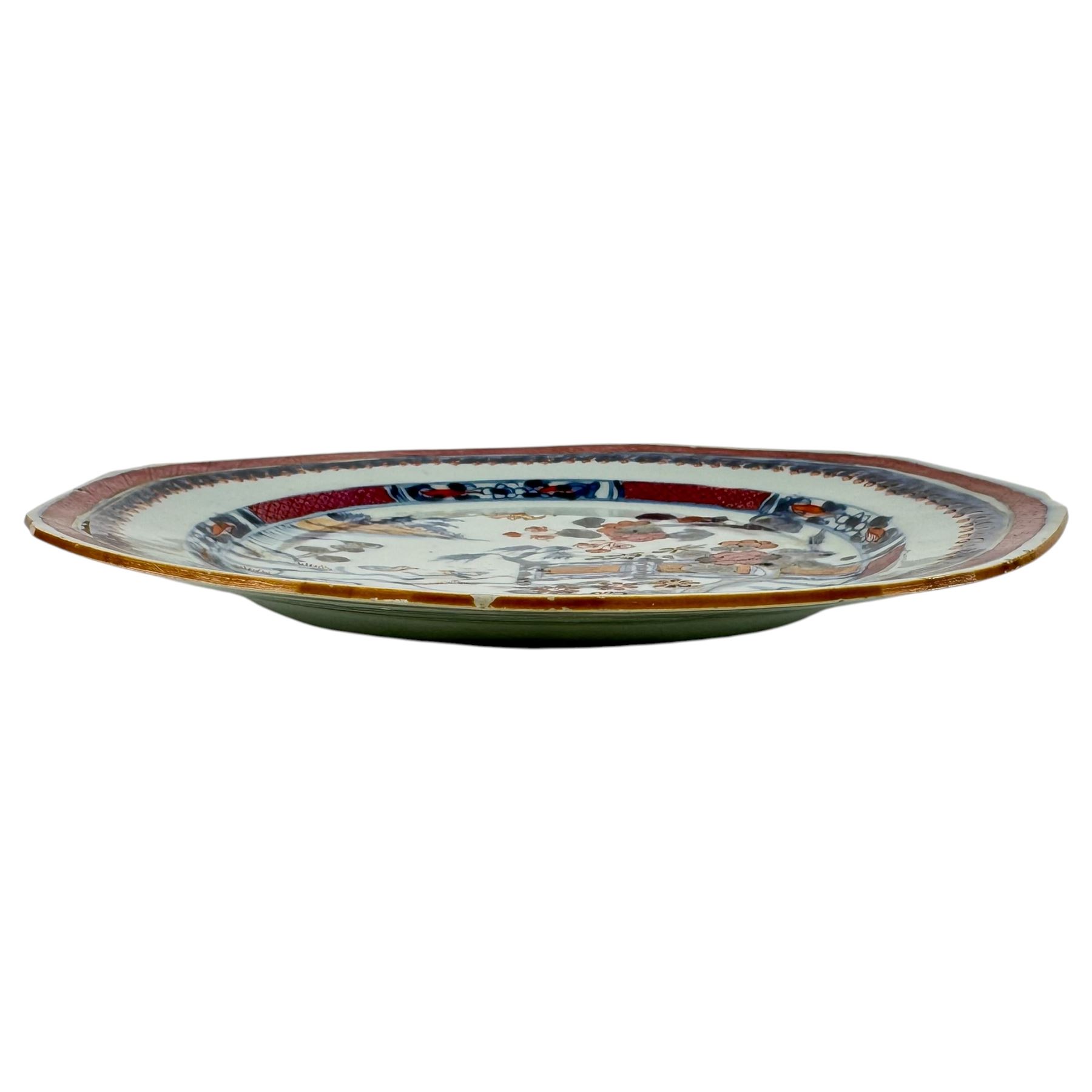Chinese Qianlong plate of hexagonal form, decorated with riverside scene in a floral boarder D23cm