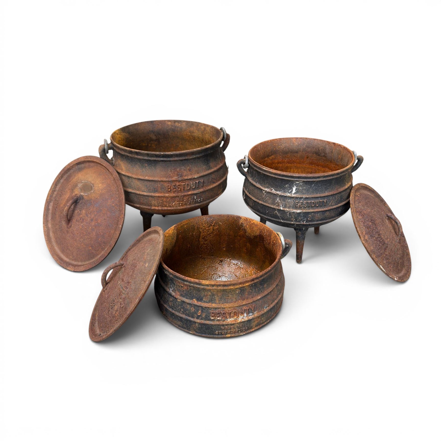 Three South African cast iron graduating cooking pots with lids and handles. Size shown for the largest