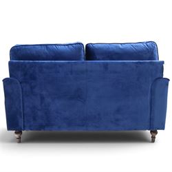 Howard design - two-seat sofa upholstered in blue fabric, traditional shape with rolled arms, on walnut finish turned feet with brushed metal cups and castors