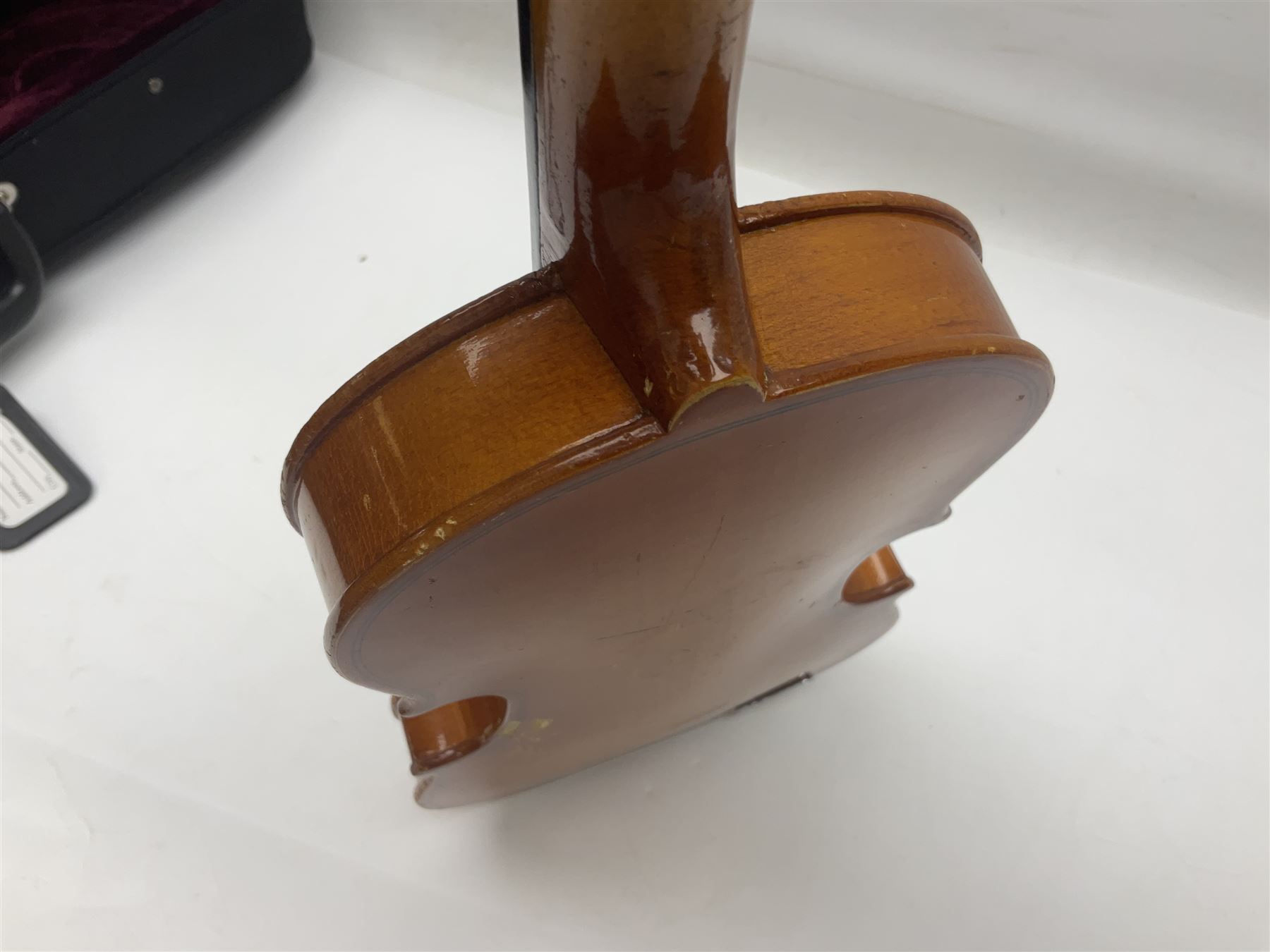 Four Chinese graduated violins - full size with 35.5cm two-piece back; three-quarter size with 33.5cm two-piece back; half size with 31cm two-piece back; and quarter size with 27.5cm two-piece back; all cased except full size; one with bow (4)