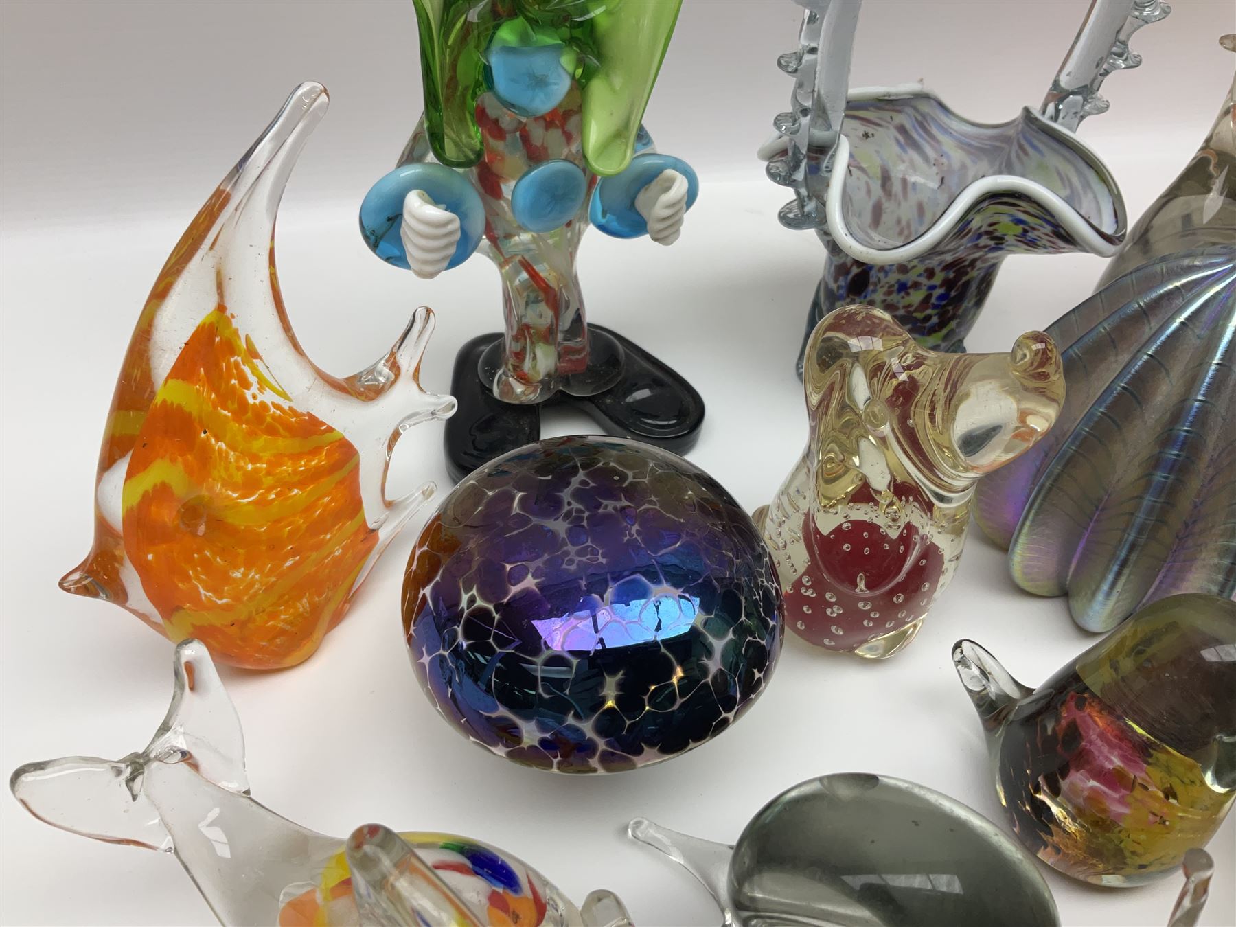 Robert Held iridescent art glass sea urchin paperweight, signed to underside, together with Murano glass clown and a collection of other glass paperweights and animals, etc 