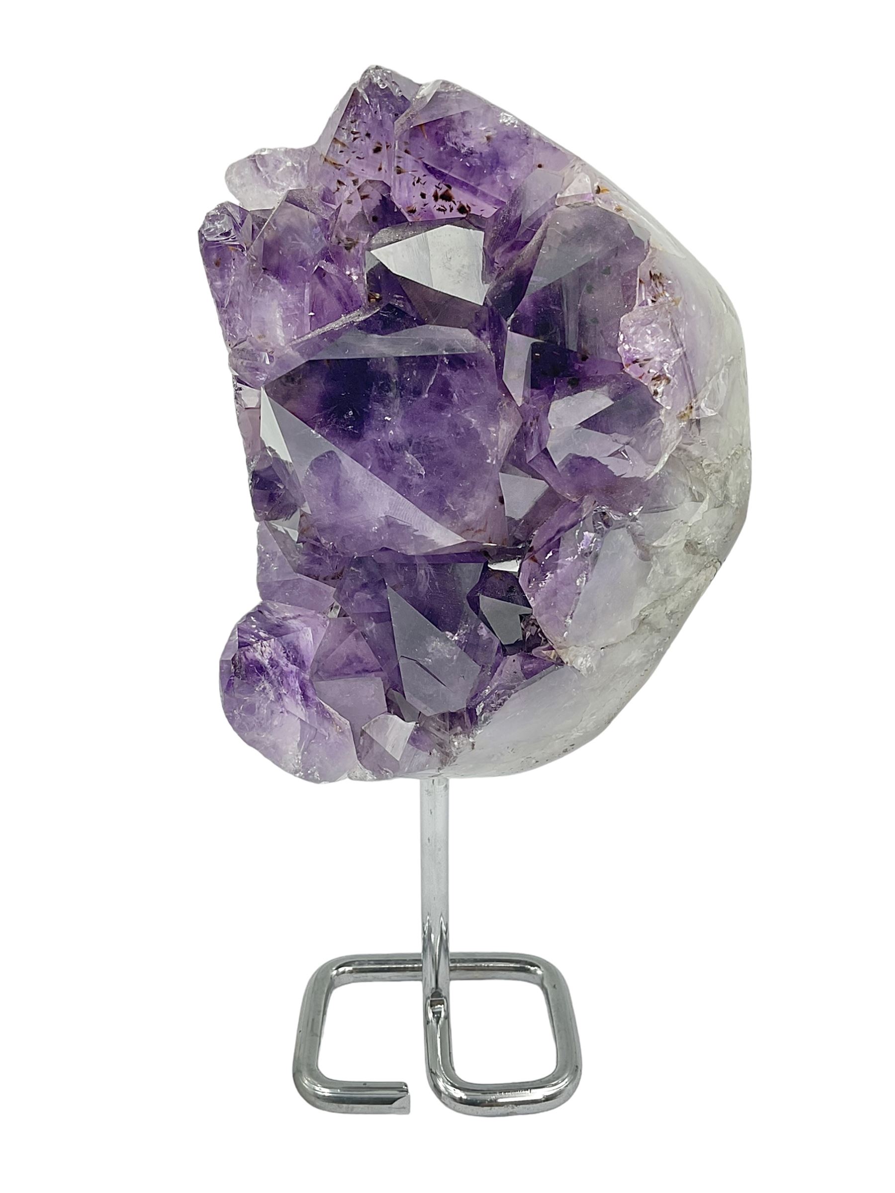 Amethyst crystal geode cluster, with large well-defined crystals, upon a metal stand, H21cm