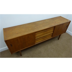  Retro teak sideboard, five drawers flanked by two sliding cupboards, turned tapering supports, W191cm, H79cm, D45cm  