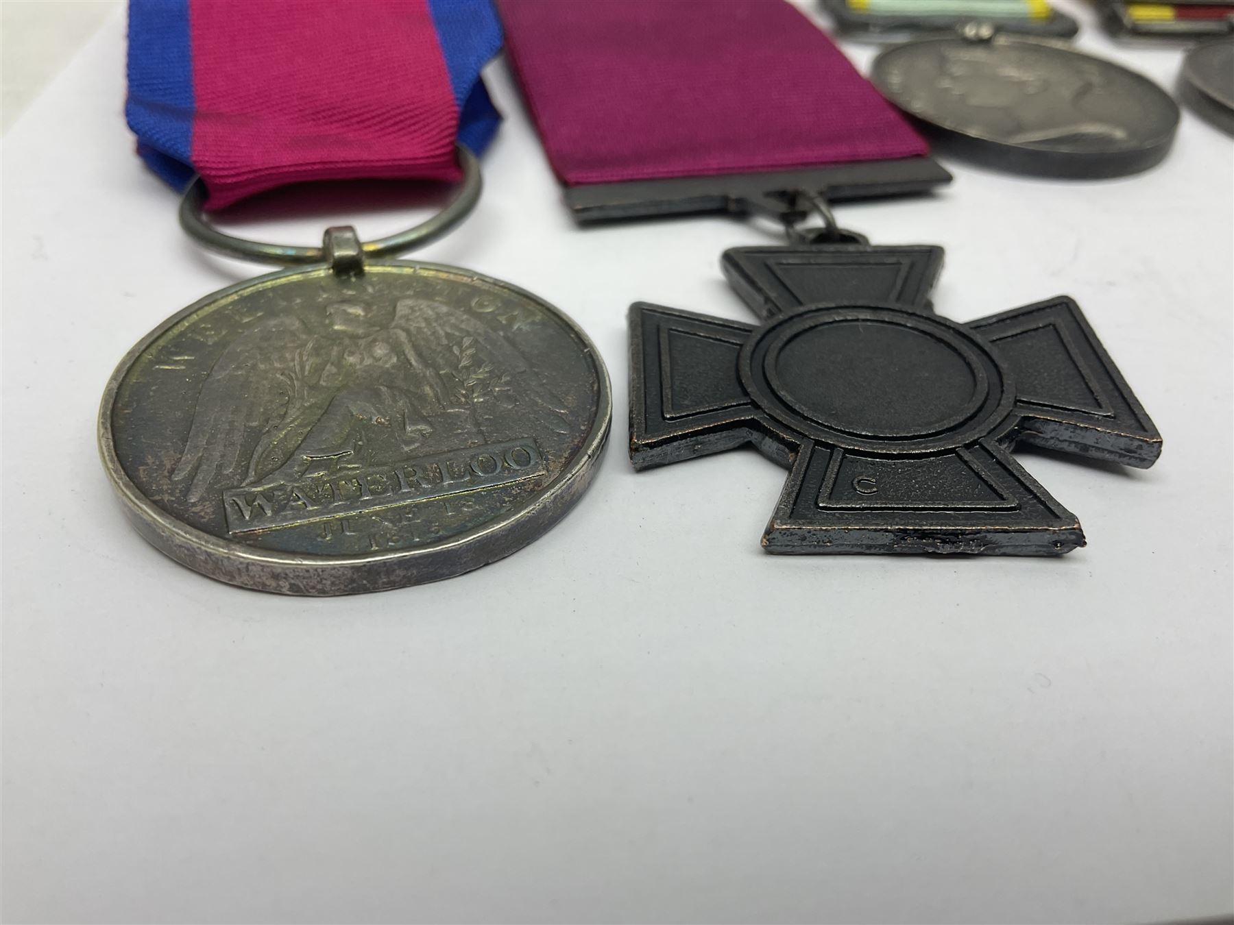 Seven copies of early medals - Waterloo, Crimea, Mediterranean, China 1900, Victoria Cross, Natal Rebellion and Tibet 1903-4; all with ribbons (7)