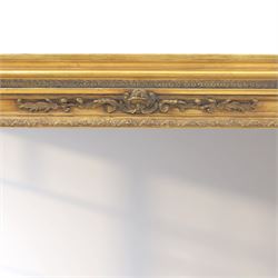 Early 20th century gilt over mantel mirror, the rectangular plate within stepped and moulded frame with central applied foliate ornament and fluted side uprights