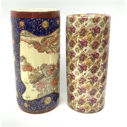 Two ceramic stick stands, the first Oriental example detailed with phoenix and flowers within a blue and gilt detailed border, H46cm, the second example printed with flowers. 