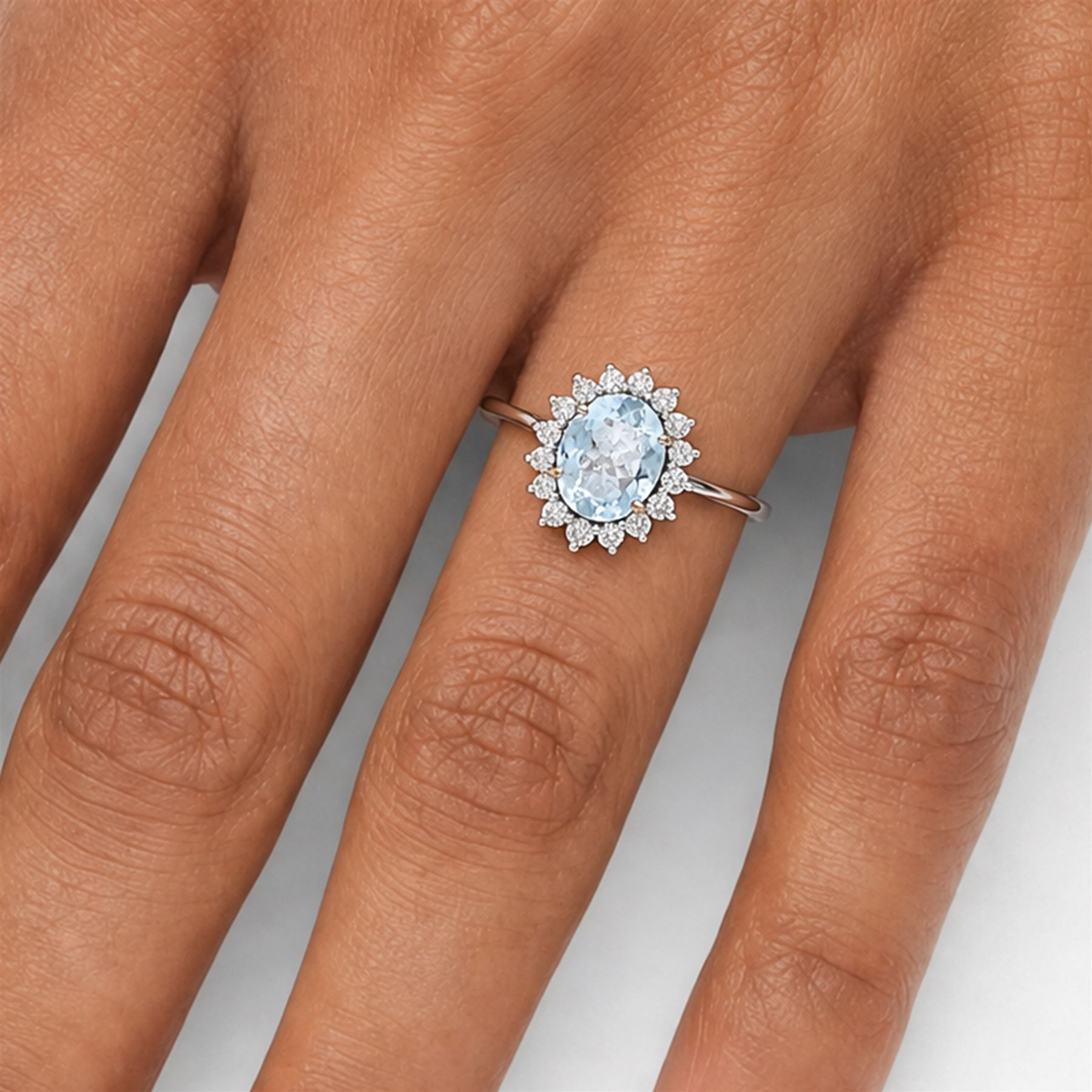 18ct white gold aquamarine and diamond cluster ring, single oval cut aquamarine of approx 2.05 carat, surrounded by sixteen round brilliant cut diamonds, stamped 18K, total diamond weight approx 0.50 carat