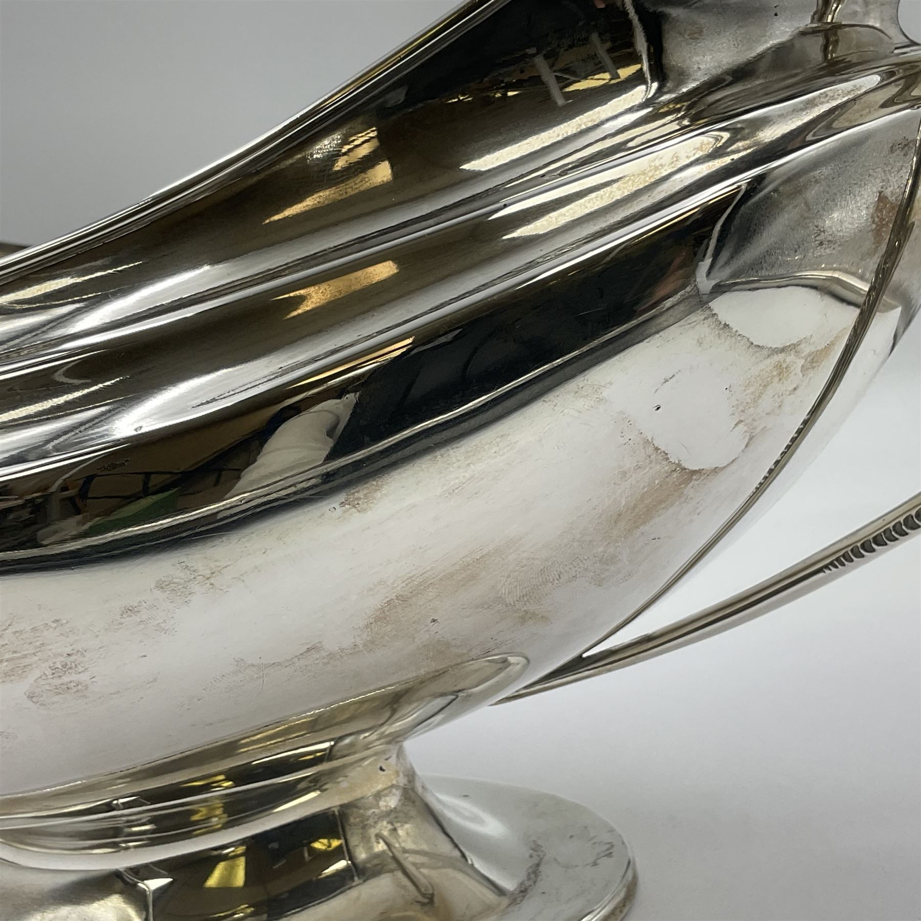 1920s silver twin-handled pedestal bowl, of navette form with twin bifurcated acanthus capped scroll handles, engraved with initial R to body and upon spreading oval foot, hallmarked Hawksworth, Eyre & Co Ltd, Sheffield 1925, including handles H21.8cm