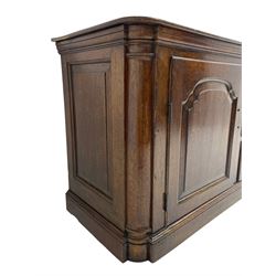 George III oak dresser base, rectangular top with rounded corners over moulded frieze rail, canted corners with turned quarter columns, fitted with three drawers with moulded edges flanked by two cupboards, enclosed by ogee arched fielded panelled doors, panelled sides, moulded plinth base