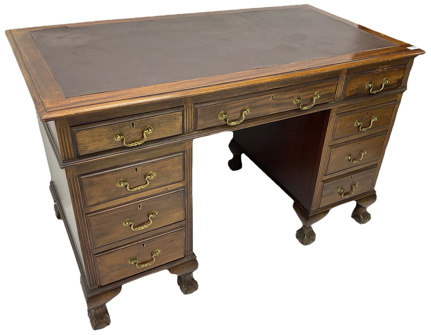 Early 20th century mahogany twin pedestal desk, fitted with nine drawers, on ball and claw carved cabriole feet