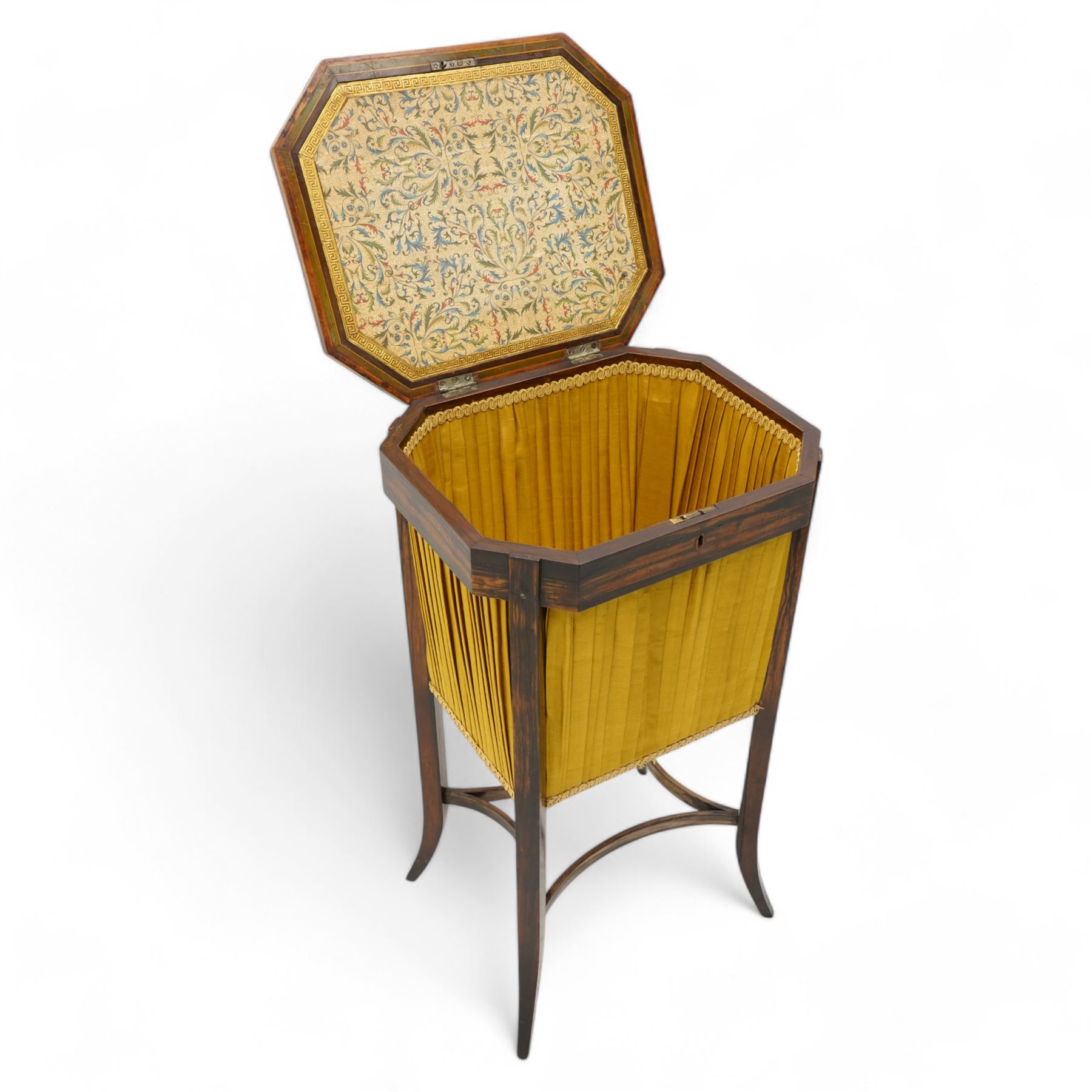 Edwardian coromandel wood work or sewing table, canted rectangular form, the hinged lid with central chinoiserie panel depicting traditional scene with boat, enclosing sunken storage well with pleated skirt, on square tapering supports with splayed feet united by curved stretchers 