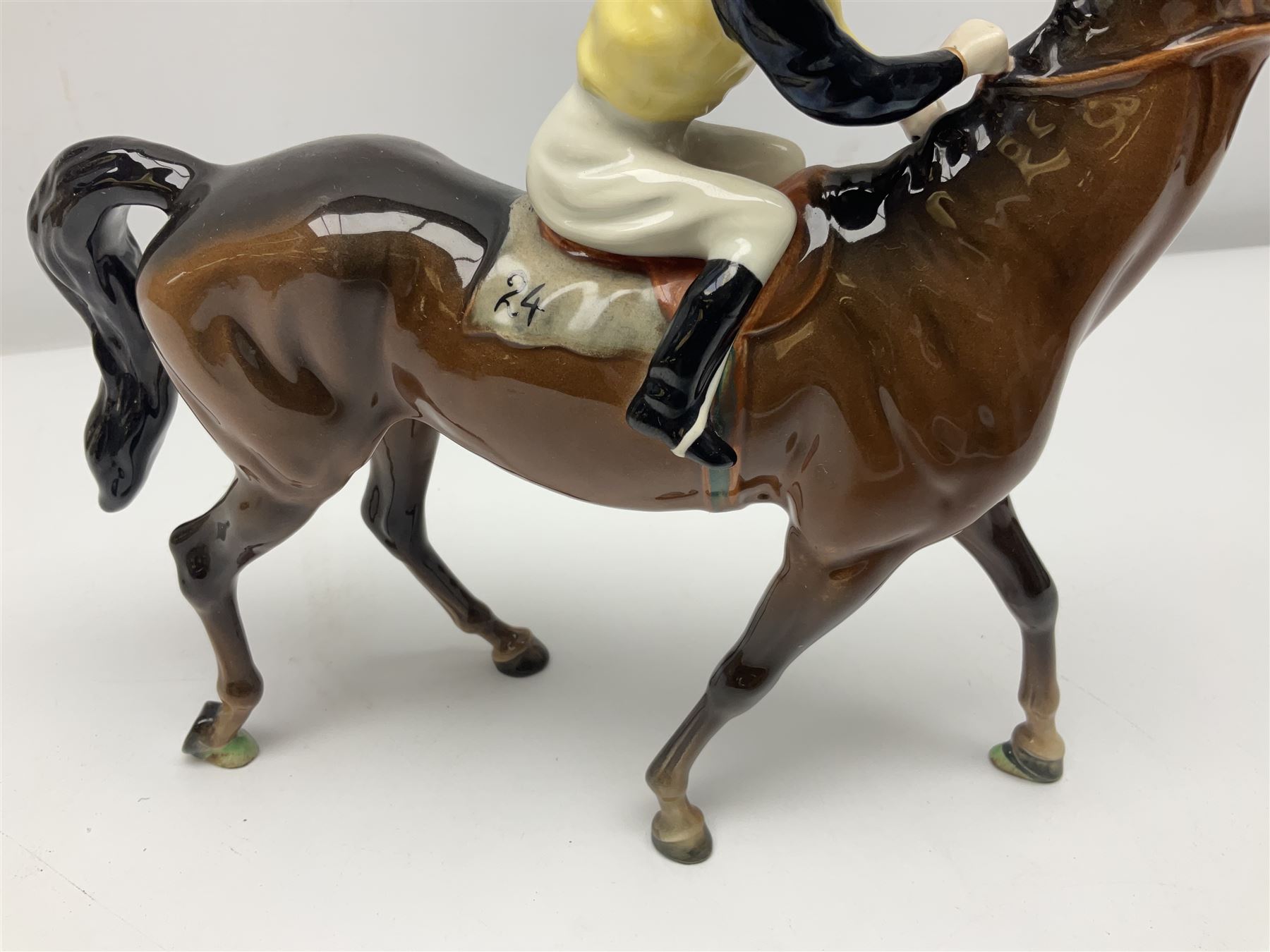 Beswick jockey on walking horse no 1037, in black white and yellow jockey colours, with printed mark beneath, H22cm