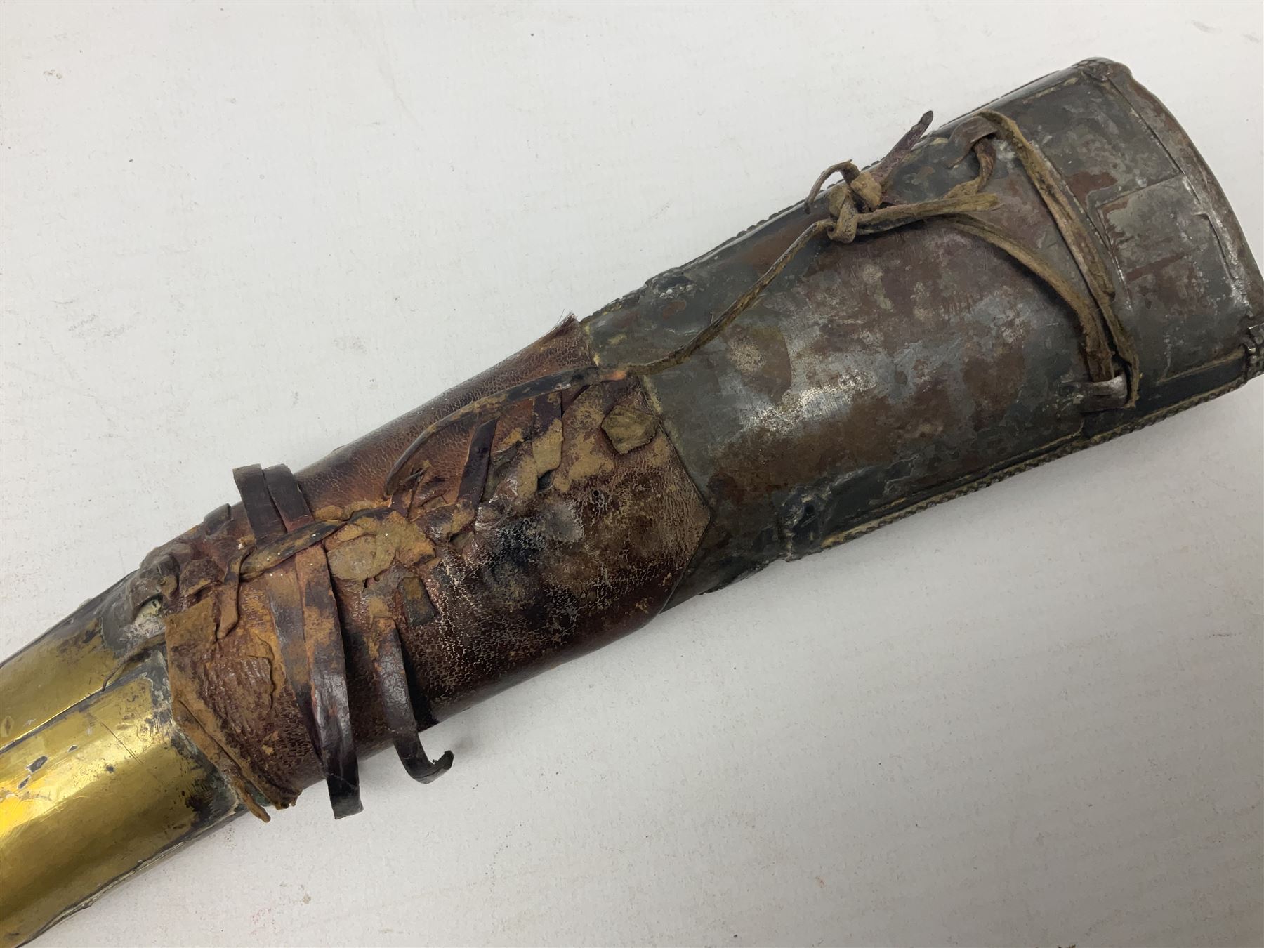 Late 19th/20th century Middle Eastern jambiya dagger the 36cm broad curved double edged steel blade with traces of script, horn and copper backed waisted white metal hilt with three roundel buttons; in ornate white metal and leather mounted brass and steel scabbard L60.5cm overall