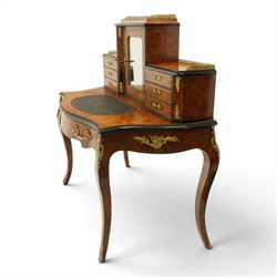 19th century French inlaid figured walnut and ebonised Bonheur de Jour or writing desk, the raised upper section with pierced brass three-quarter gallery, over a mirror glazed cupboard and a combination of drawers, the shaped and moulded top with leather inset and satinwood stringing, with brass beading too the ebonised edge, fitted with a serpentine fronted frieze drawer, raised on cabriole supports, inlaid throughout with scrolling foliate decoration in boxwood and ornate cast brass mounts and handles
