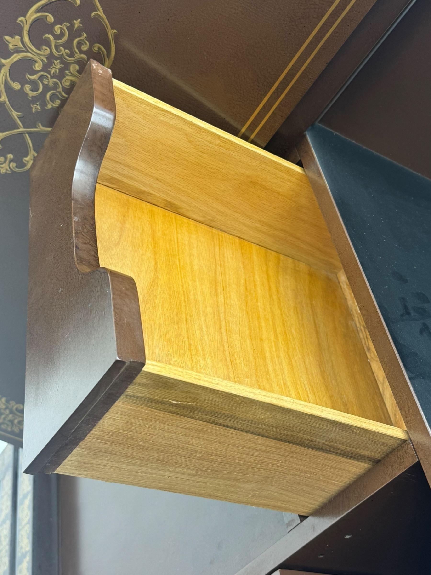 Chinese brown lacquered cocktail cabinet, decorated with gilt scenes of a traditional landscape with figures, pagodas, and mountainous scenery, double doors opening to reveal fitted interior with mirrored back, wine rack, shelves and cupboard, raised on square supports