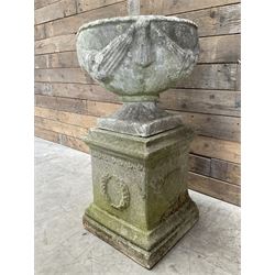 Cast stone centerpiece urn on plinth