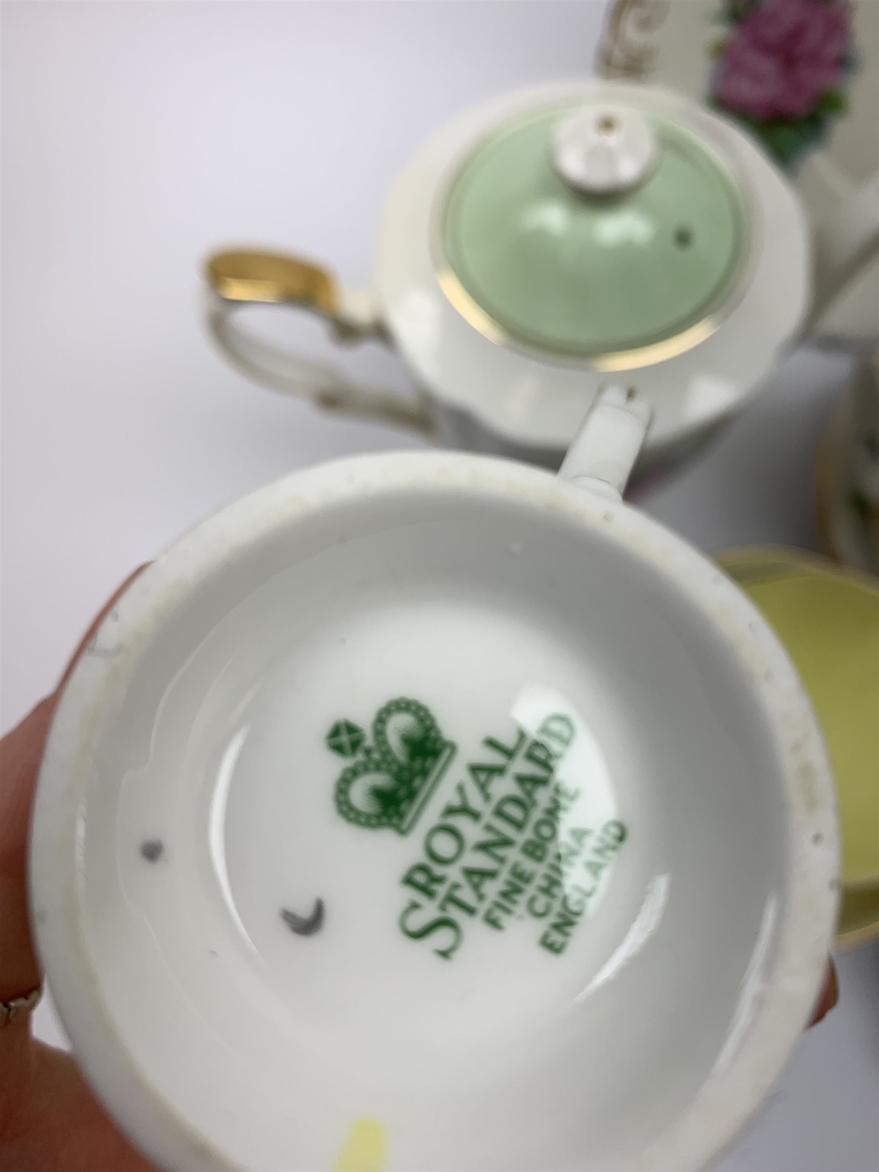 Royal Standard Harry Wheatcroft 'World Famous Roses' tea and coffee wares, comprising teapot, six teacups and six saucers, six coffee cups and five saucers, six side plates, milk jug, cream jug, two open sucriers, and sandwich plate. 