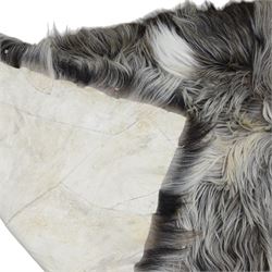 Skins/Hides: cow hide with brown and white dappled pattern together with another hide, possibly Mongolian goat