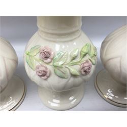 Five late 19th/early 20th century and later Belleek vases, comprising pair of Lotus Blossom examples, shamrock tree trunk vase, twin handled shamrock vase and a baluster form vase decorated with applied roses, all with printed marks beneath, tallest H16cm