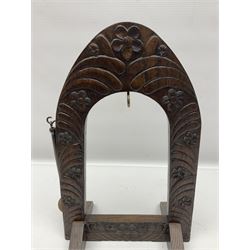 Chinese brass temple bell, decorated in high relief with a a dragon chasing a flaming pearl, within a carved floral hardwood stand, H36cm