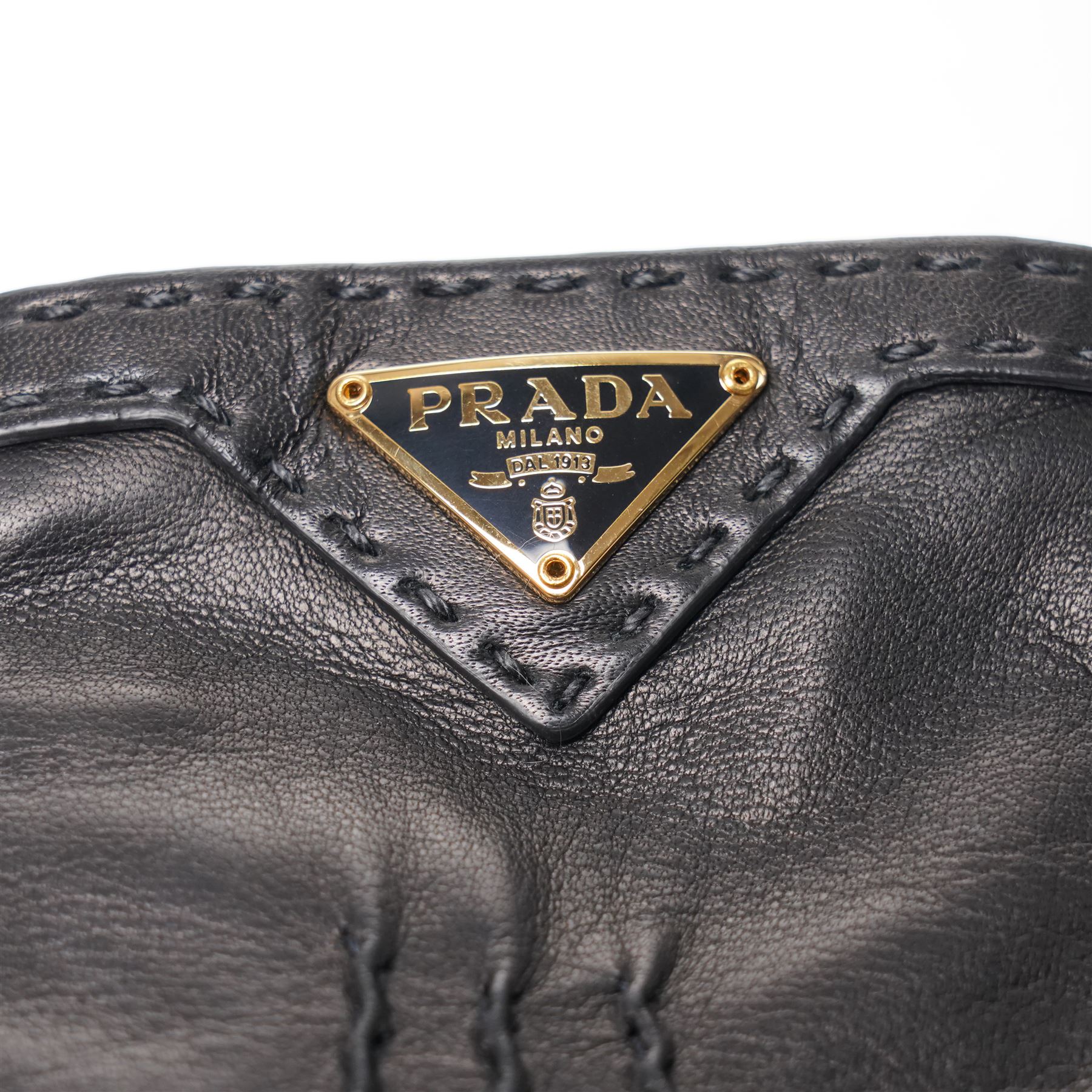 Prada - pair of black lambskin leather gloves, with enamel gold-tone and black triangle logos and silk lined interior, unused with original box