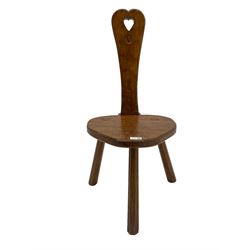 Acornman - adzed oak spinning chair, spoon shaped back with pierced heart and acorn signature, spade-shaped seat raised on octagonal tapering supports by Alan Grainger of Brandsby