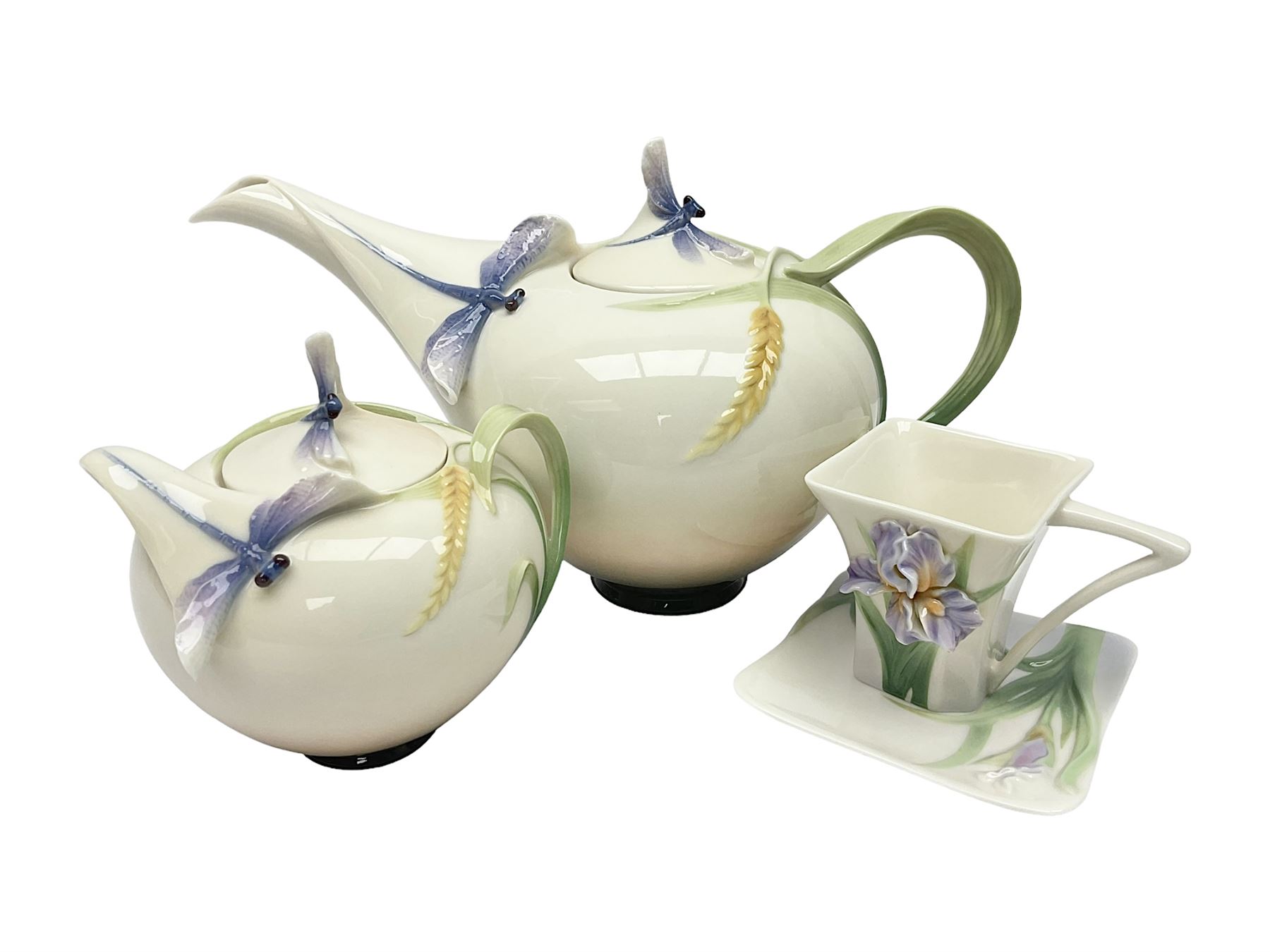 Franz Teapot decorated with dragonflies, together with a matching sucrier and cover and a cup and saucer in Iris pattern, all with printed mark beneath 