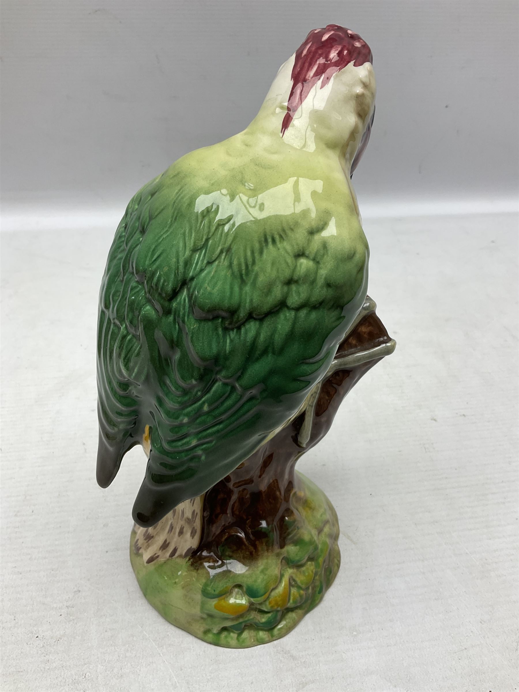 Three Beswick figures of birds, comprising pheasant no 1225, magpie no 2305 and woodpecker 1218, all with impressed marks beneath, tallest H22cm