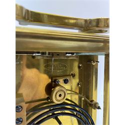 Early to mid 20th century French brass and bevelled glass cased carriage clock, the shaped loop handle over oval glass panel, white enamel Roman dial, twin train driven eight day movement striking on coil, with button push repeater, the movement back plate stamped for 'R & Co.'