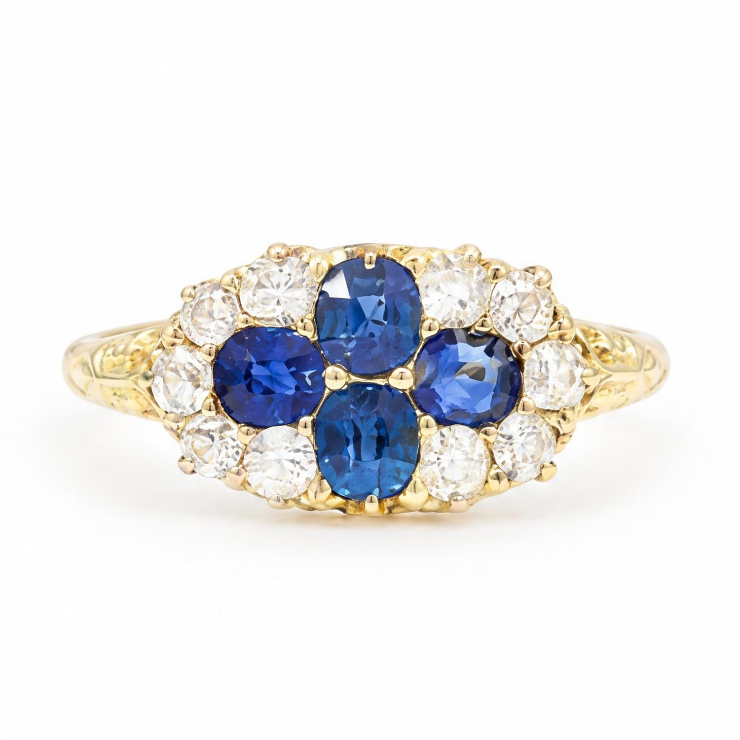 Victorian sapphire and diamond cluster ring, four oval cut sapphires, surrounded by eight old cut diamonds, with scroll design shoulders
