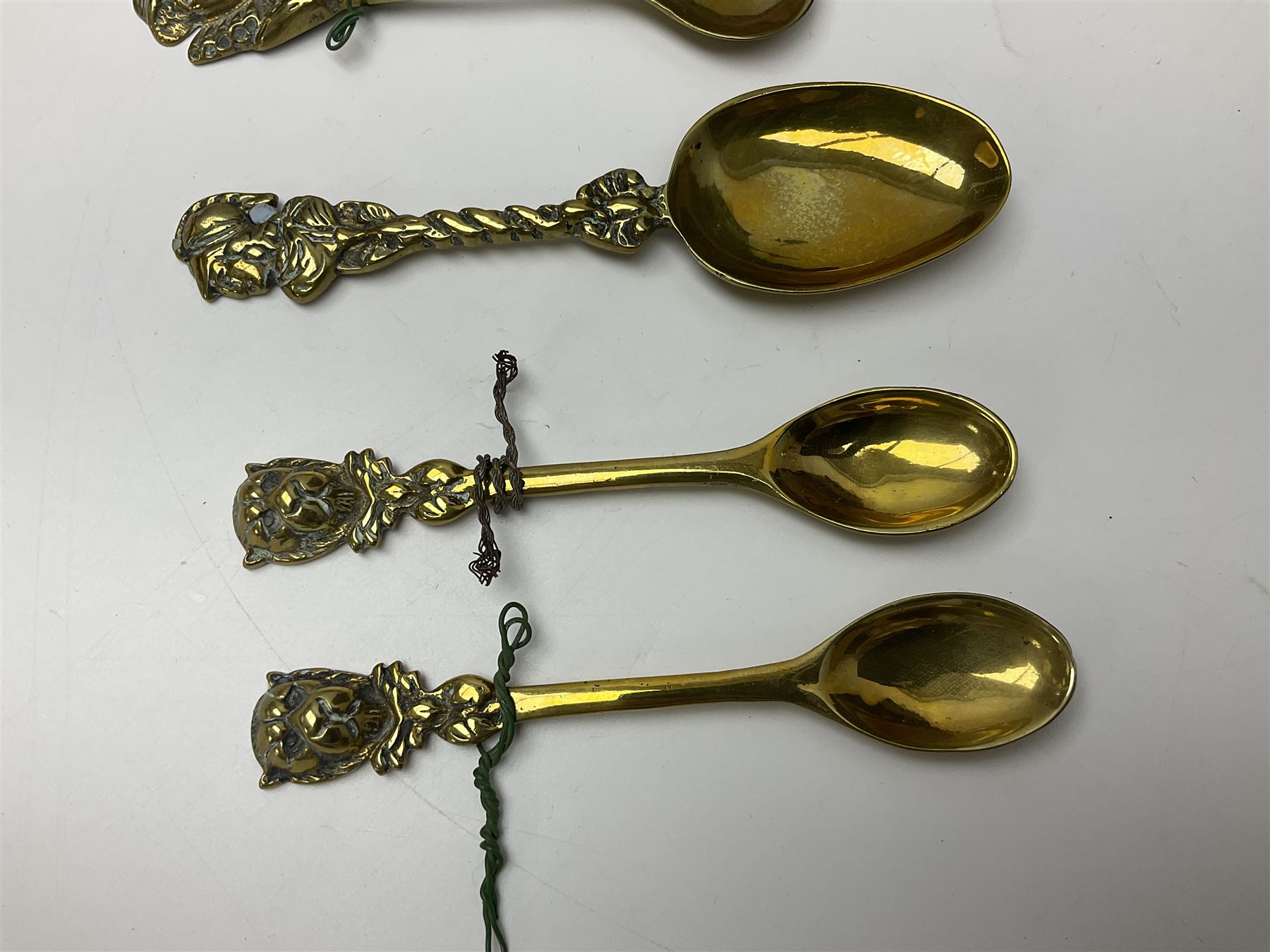 George III oak spoon rack and candle box, the rectangular backplate with shaped  pediment and two six aperture spoon racks, above a candlebox with hinged cover, with various brass spoons and a pair of brass candle snuffers, H56.5cm, W35cm, D14cm 