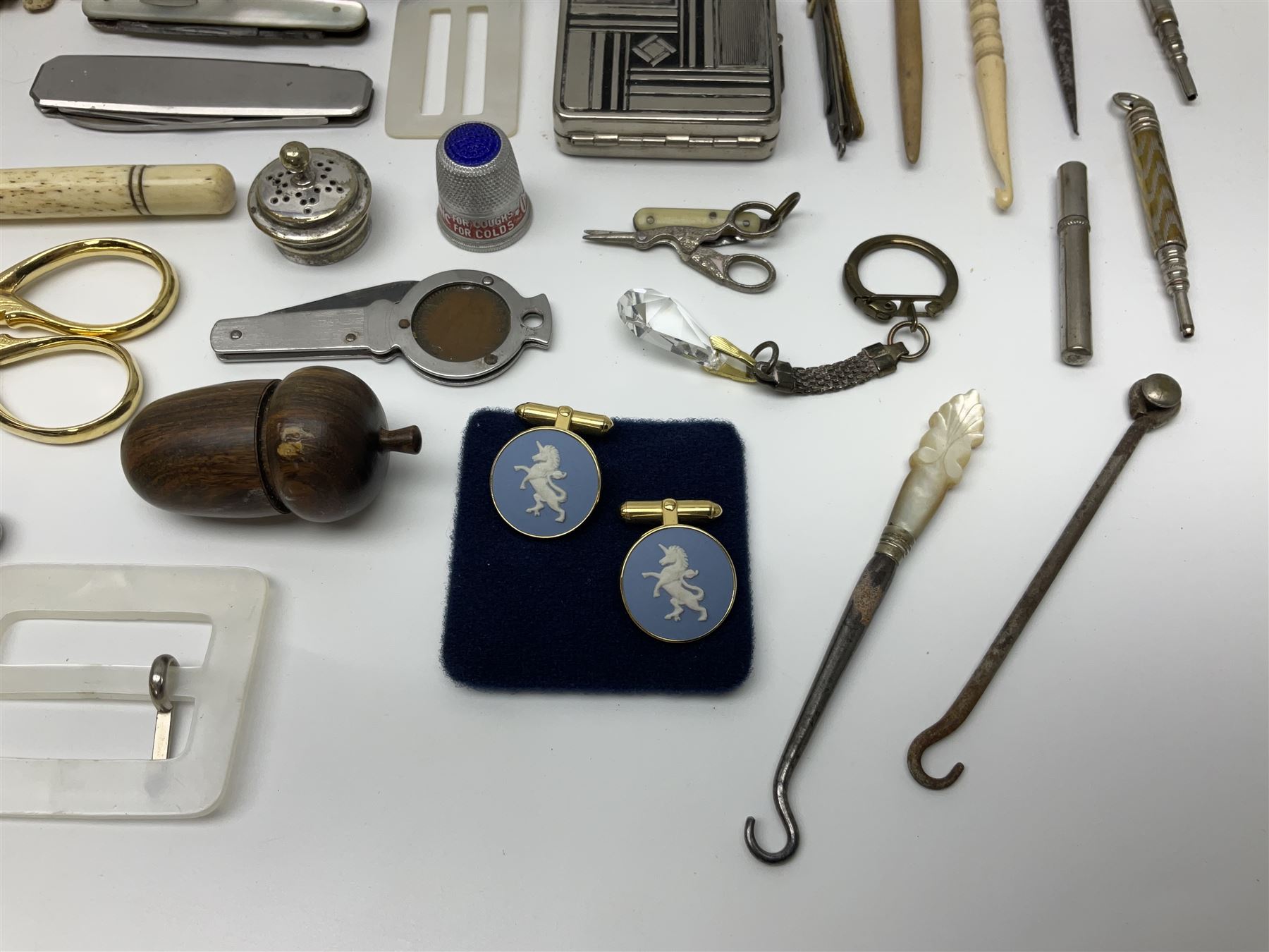 Pair of Wedgewood jasperware unicorn cufflinks, silver handled part manicure set, enamel flip notebook, dolls leather gloves, Stratton compact, and a collection of sewing accessories including thimbles, button hooks, thimble holder, scissors etc 