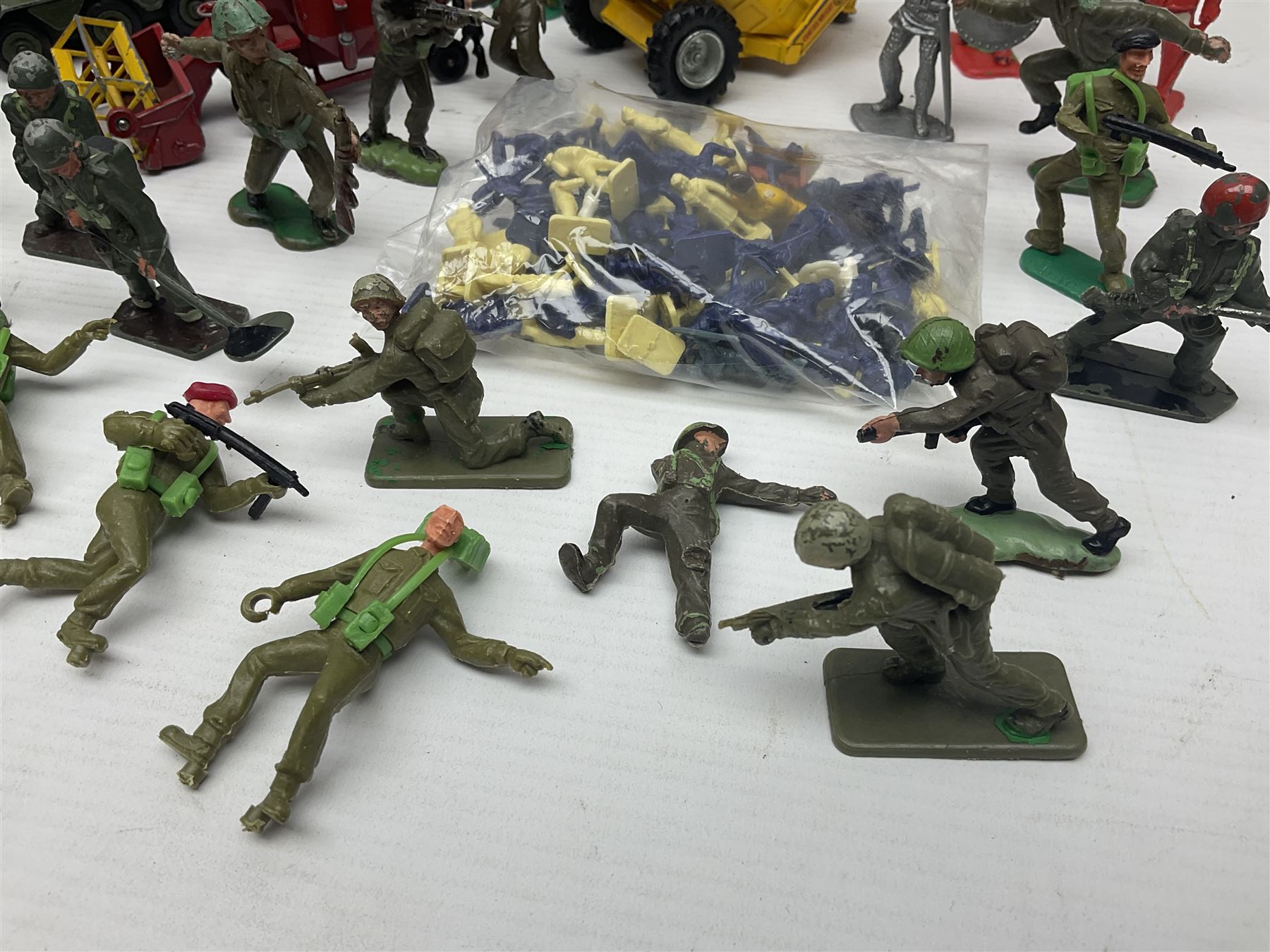 Various makers - unboxed and playworn die-cast models including Dinky Thornycroft Mighty Antar Tank Transporter No.660 and Centurion Tank No.651, other military and farm vehicles; and quantity of loose plastic soldiers and other figures by Crescent, Britains etc