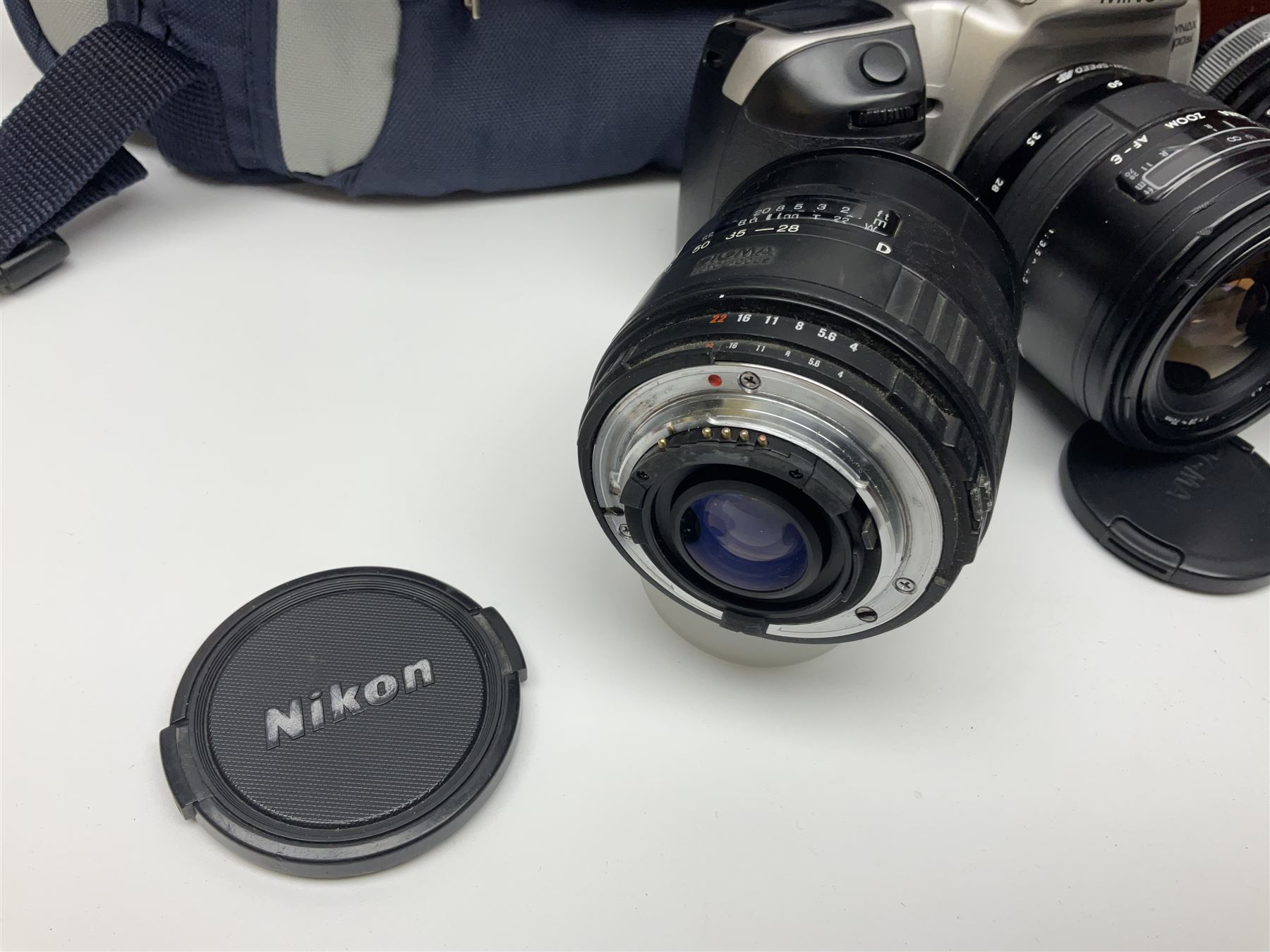 Four Minolta camera bodies, to include Dynax 500si, serial no. 94812651 with 'Signa Zoom 1;3.5-4.5 f=28-70mm' lens, Maxxum 300si, serial no. 97821665, with 'Tamron AF 80-210mm' lens and Dynax 300si, serial no 01603265'  with Minolta AF Power Zoom 35-80mm 1;4' lens, etc, together with Pantax MV1 camera bodies and other camera equipment 