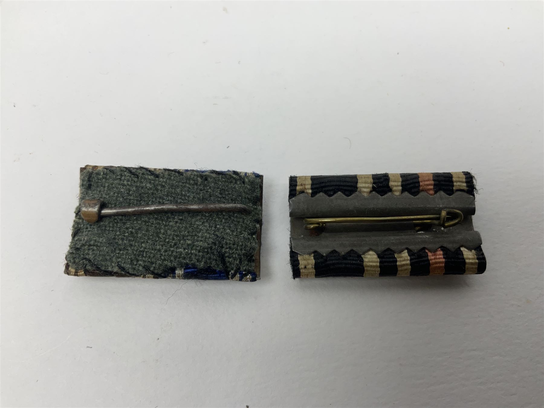 Collection of eleven German metal and cloth badges and uniform buttons including driver's badge, two 'SS' fabric skulls, private's shoulder tabs, Police cloth badge, tank destruction badge, medal bars and ribbon etc; most WW2 period