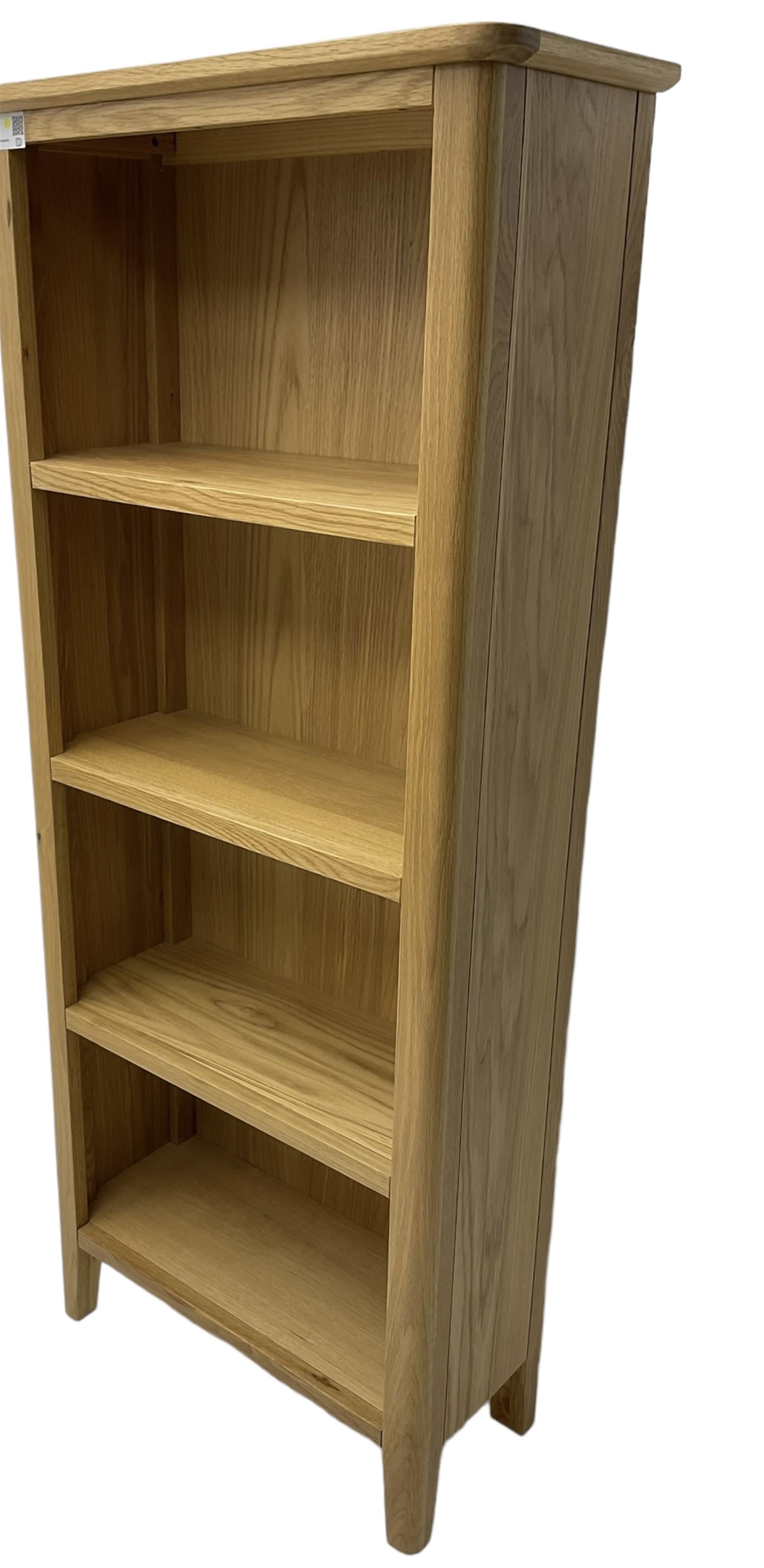 Contemporary light oak open bookcase, fitted with three shelves, on tapering supports